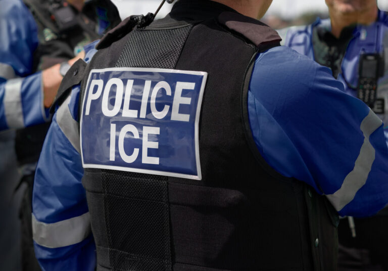 ICE officer vest during enforcement operation – ICE personal injury attorneys helping victims of federal agent misconduct