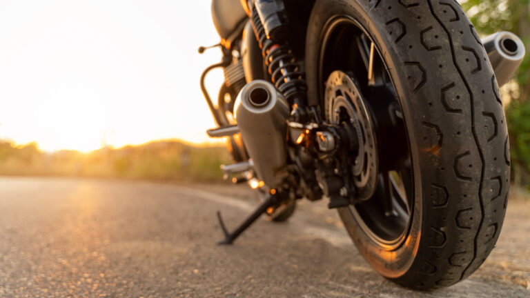 Motorcycle accident scene in Los Angeles highlighting a motorcycle wheel and exhaust for a motorcycle attorney Los Angeles case